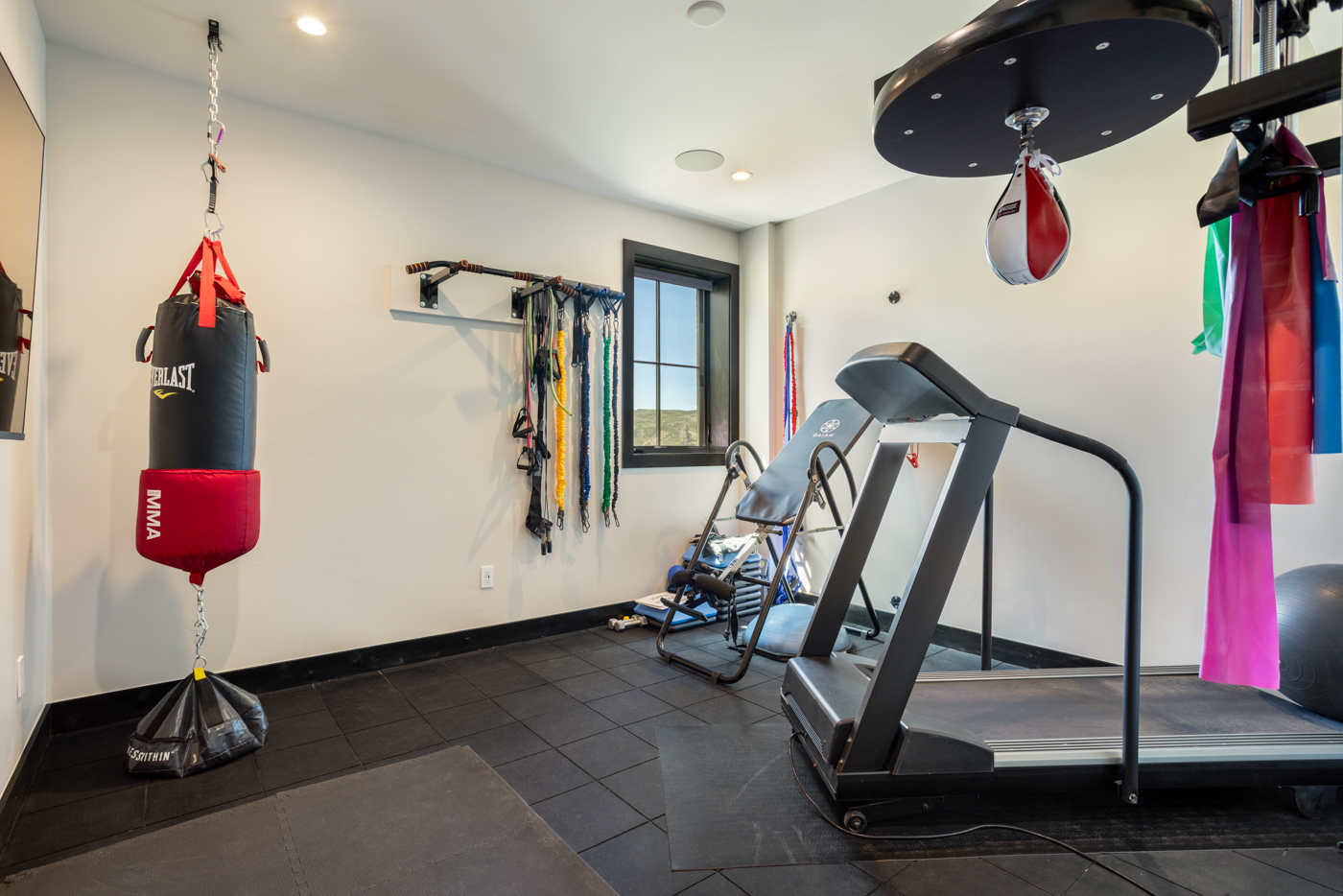 Home gym with rubber flooring and full equipment setup
