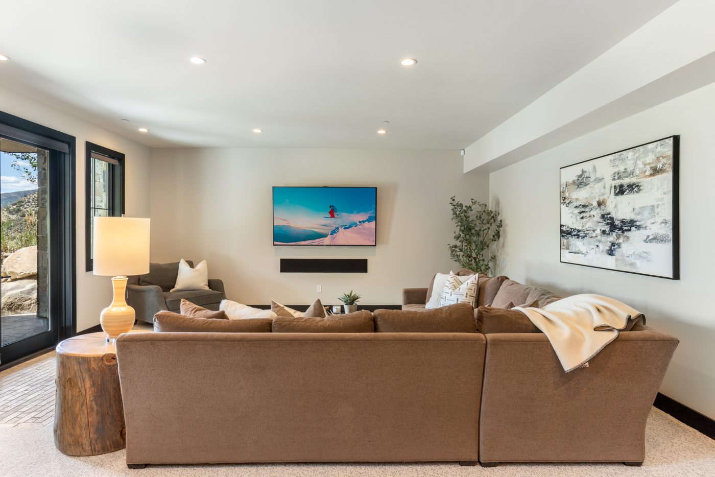Family room sectional with patio doors to the lower terrace
