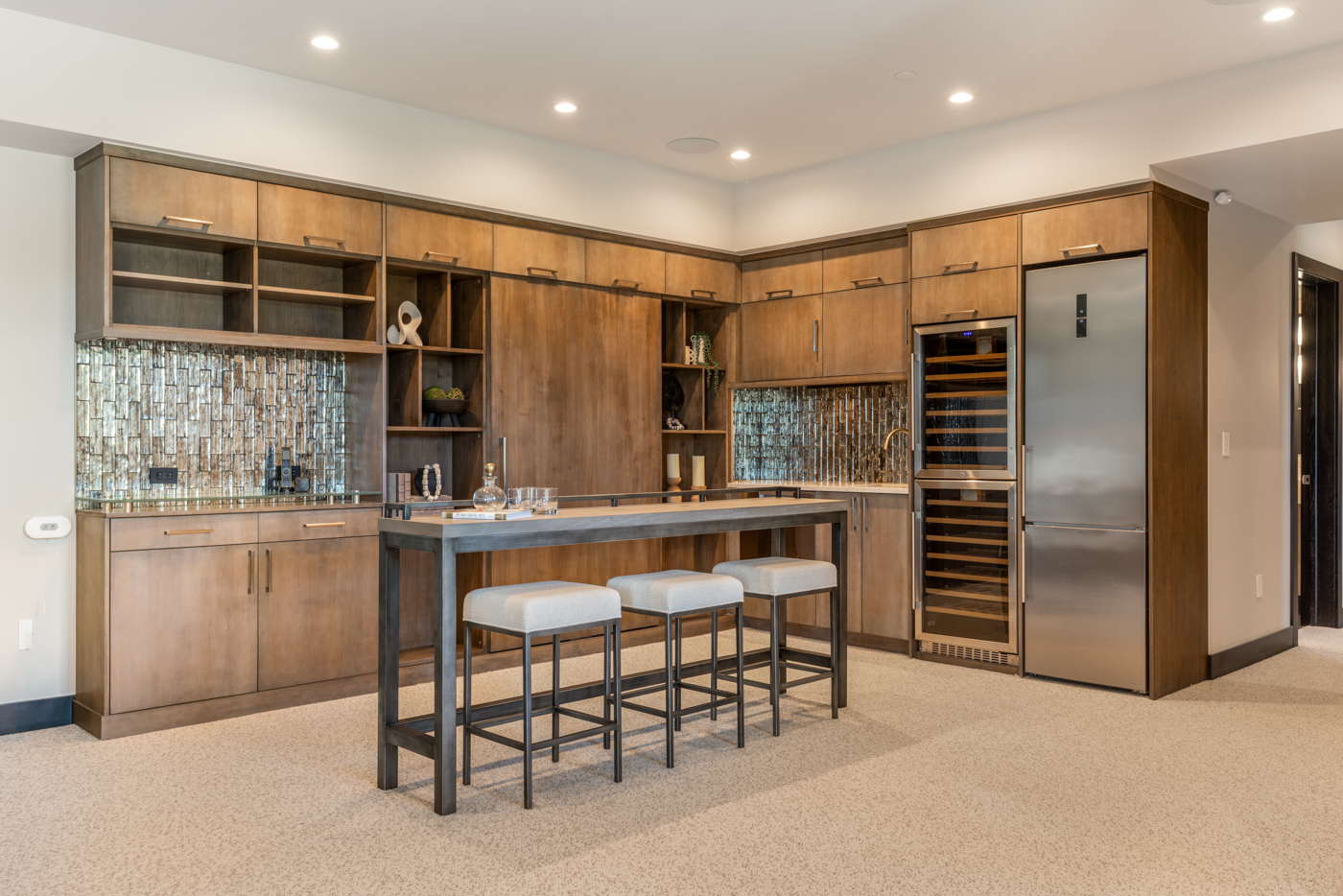 Lower-level wet bar with wine refrigeration and bar-height island