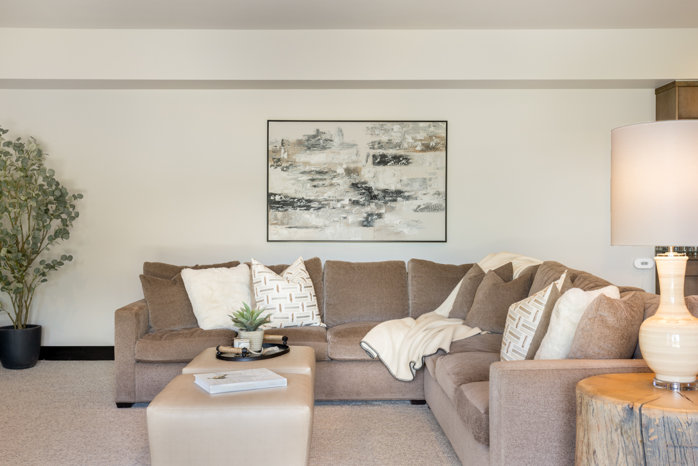 Family room seating with layered lighting and art